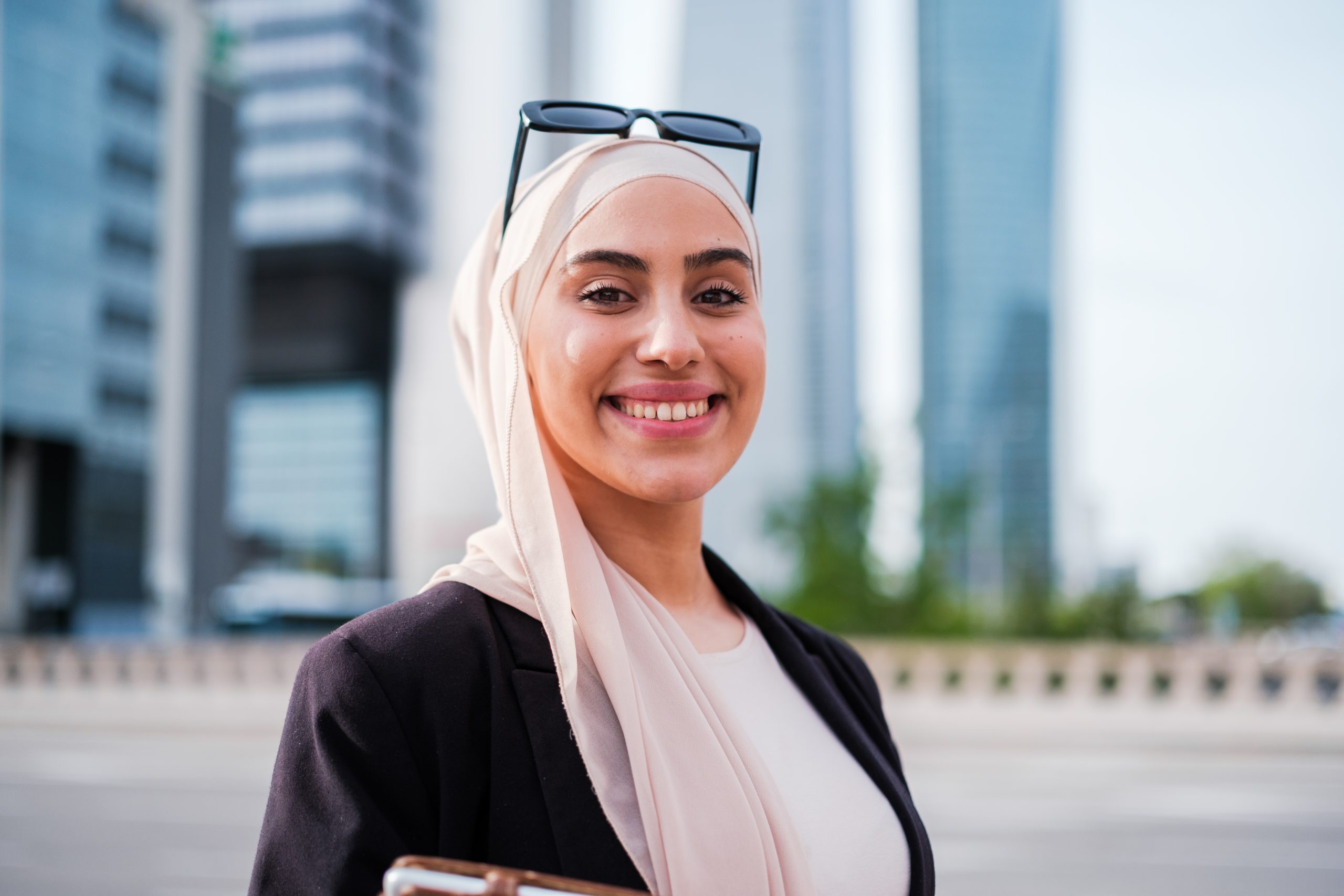 Corporate portrait of young businesswoman with hijab in financial district